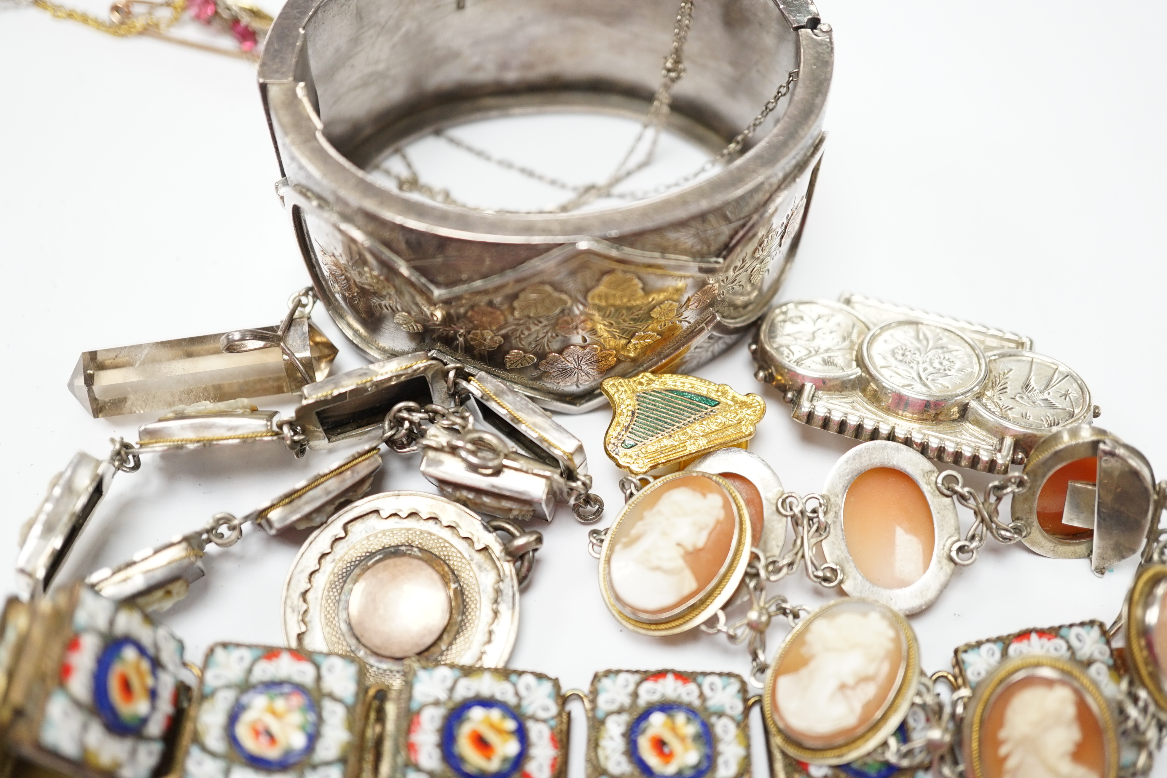 Assorted Victorian and later jewellery including a late Victorian three colour yellow metal and silver bangle, a white metal brooch with aesthetic engraved decoration, cameo mother of pearl and shell bracelets, micro mos
